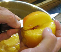 Slicing the peeled peaches.